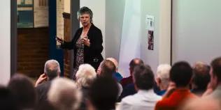 Professor Gill Reid giving a presentation to an audience