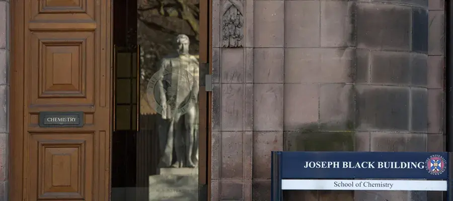 A statue reflected in a doorway