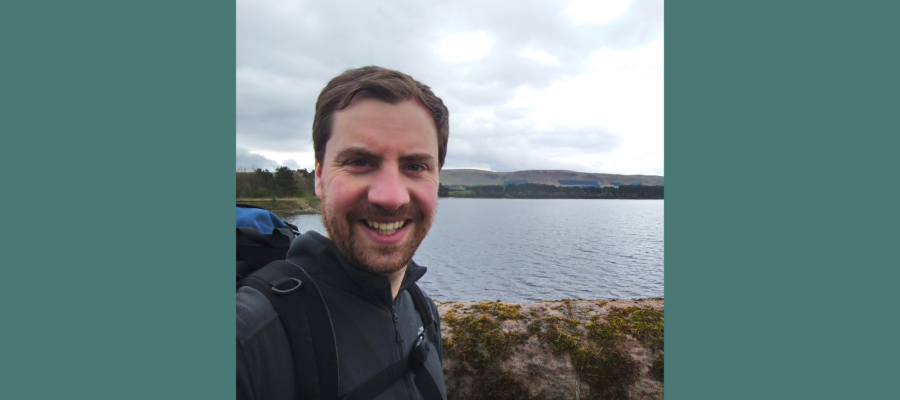 Alumnus David August with a loch in the background