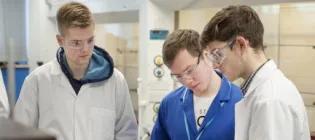 A postgraduate student talking to high school students