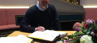 Philip signing the register