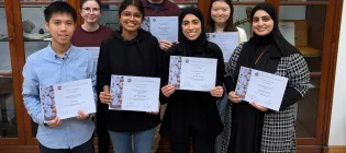 Image of PGT student award winners with certificates