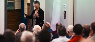 Professor Gill Reid giving a presentation to an audience