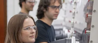 Members of the Pyrochemical Research Laboratory doing work in glove boxes.