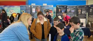 Visitors learning how photochemical reactions produce blueprint artwork from Dr Jenny Gracie
