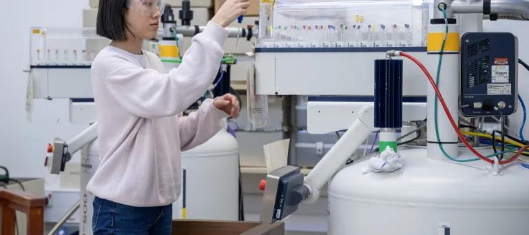 Researcher loading samples in the NMR facility
