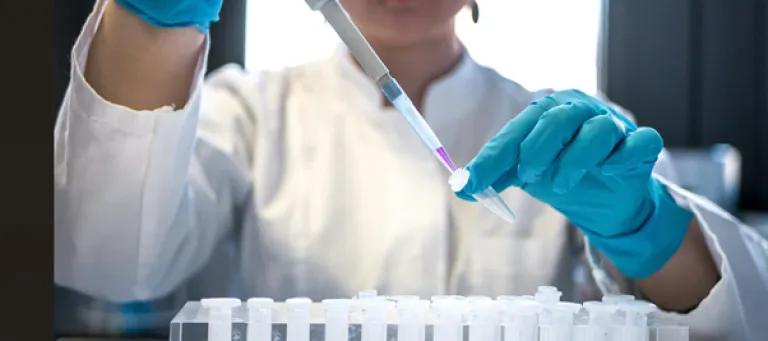 Scientist with a pipette and eppendorfs