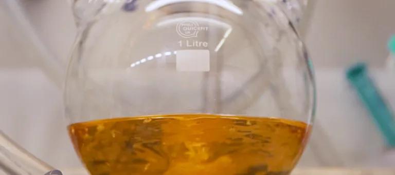 Round bottom flask containing orange liquid