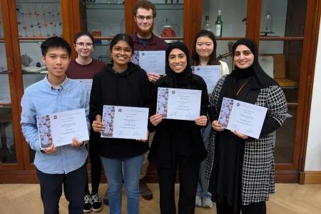 Image of PGT student award winners with certificates