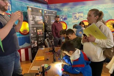 Visitors learning about solar power from PhD student Kieran