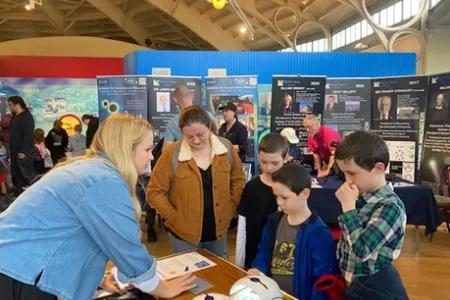 Visitors learning how photochemical reactions produce blueprint artwork from Dr Jenny Gracie