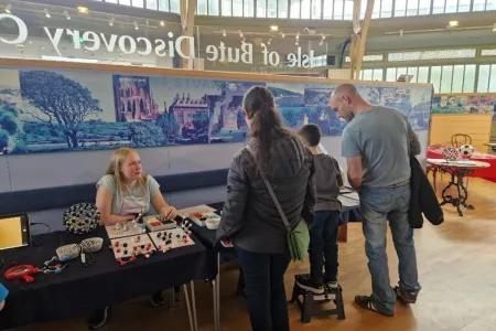 Visitors learning about molecular shapes from PhD student Emma Tomlinson.