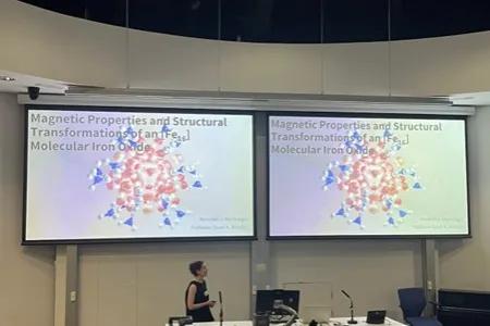 Annabel presenting at USIC with screens showing her slides