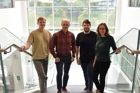 Four members of the Horrocks Group posing on stairs