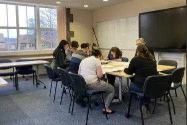 Researchers reviewing documents sitting at a table
