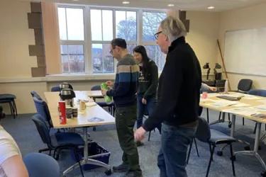 Researchers reviewing documents sitting at a table