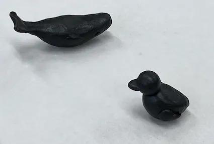 Reclaimed metal sculpture of a whale and duck
