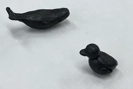 Reclaimed metal sculpture of a whale and duck