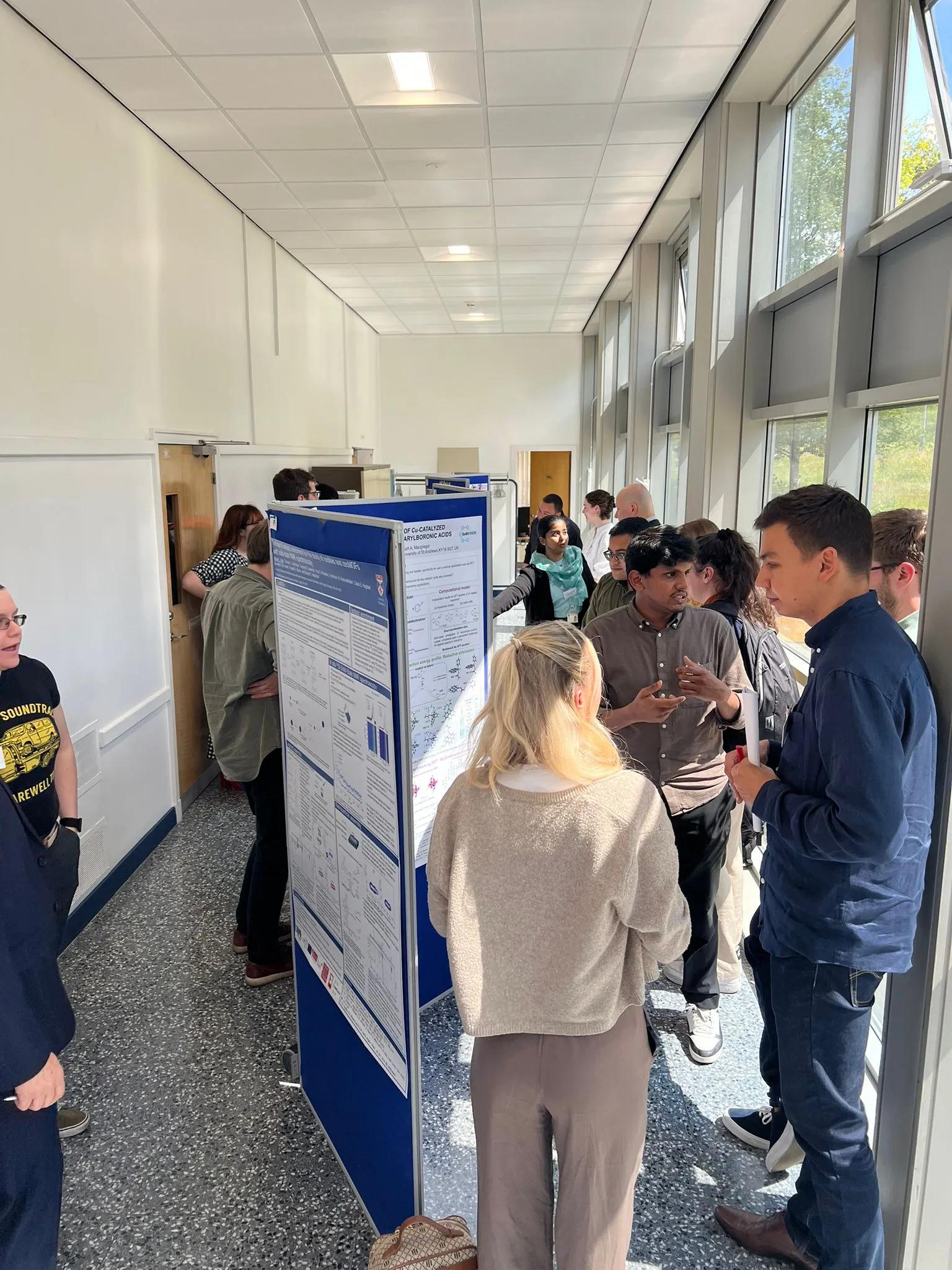 Conference attendees networking during a poster session.