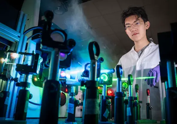 Scientist in front of a laser