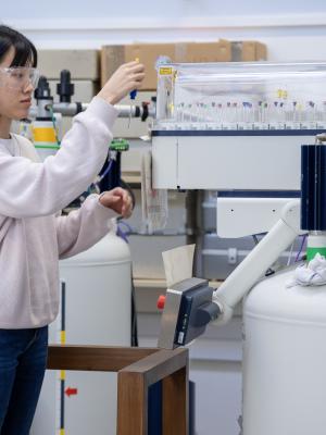 Researcher loading samples in the NMR facility