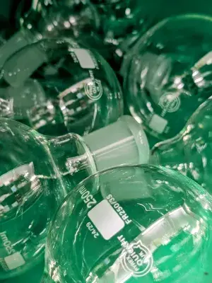 Close up image of flasks against a green background