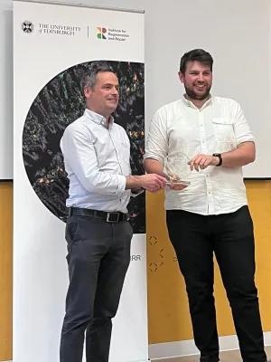 Photo of Dan receiving his prize.